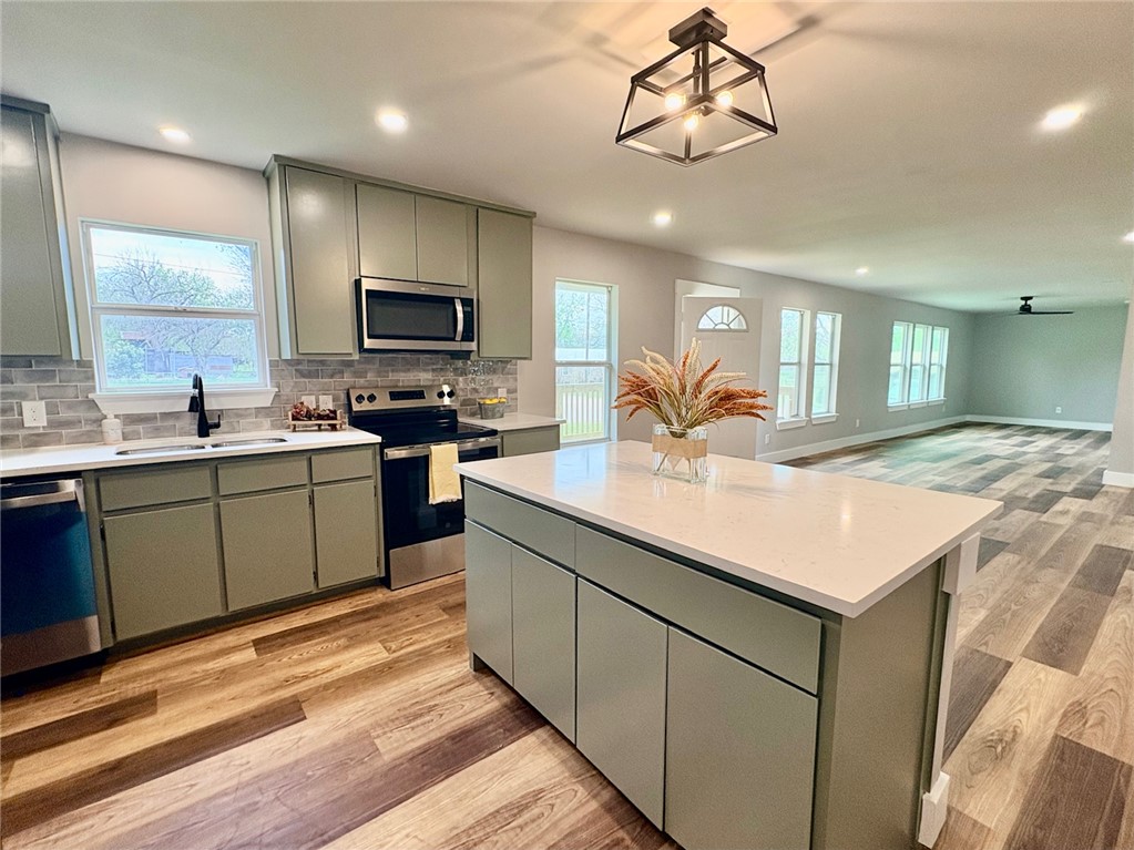 102 Terral Court Cameron, TX 76520 - Photo 5 of 14 a kitchen with a sink refrigerator and microwave