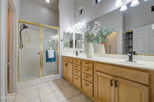a spacious bathroom with double sink and shower