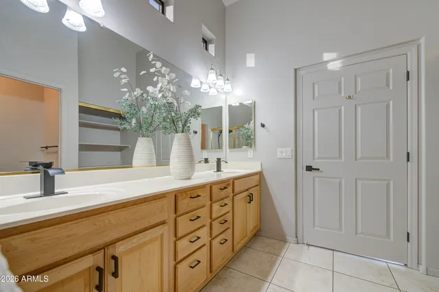 a bathroom with a double vanity sink and a mirror