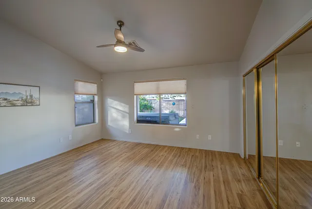 wooden floor in an empty room with a window