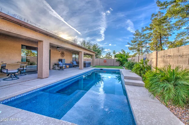 a view of swimming pool with outdoor seating