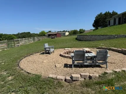 a view of a lake with a table and chairs