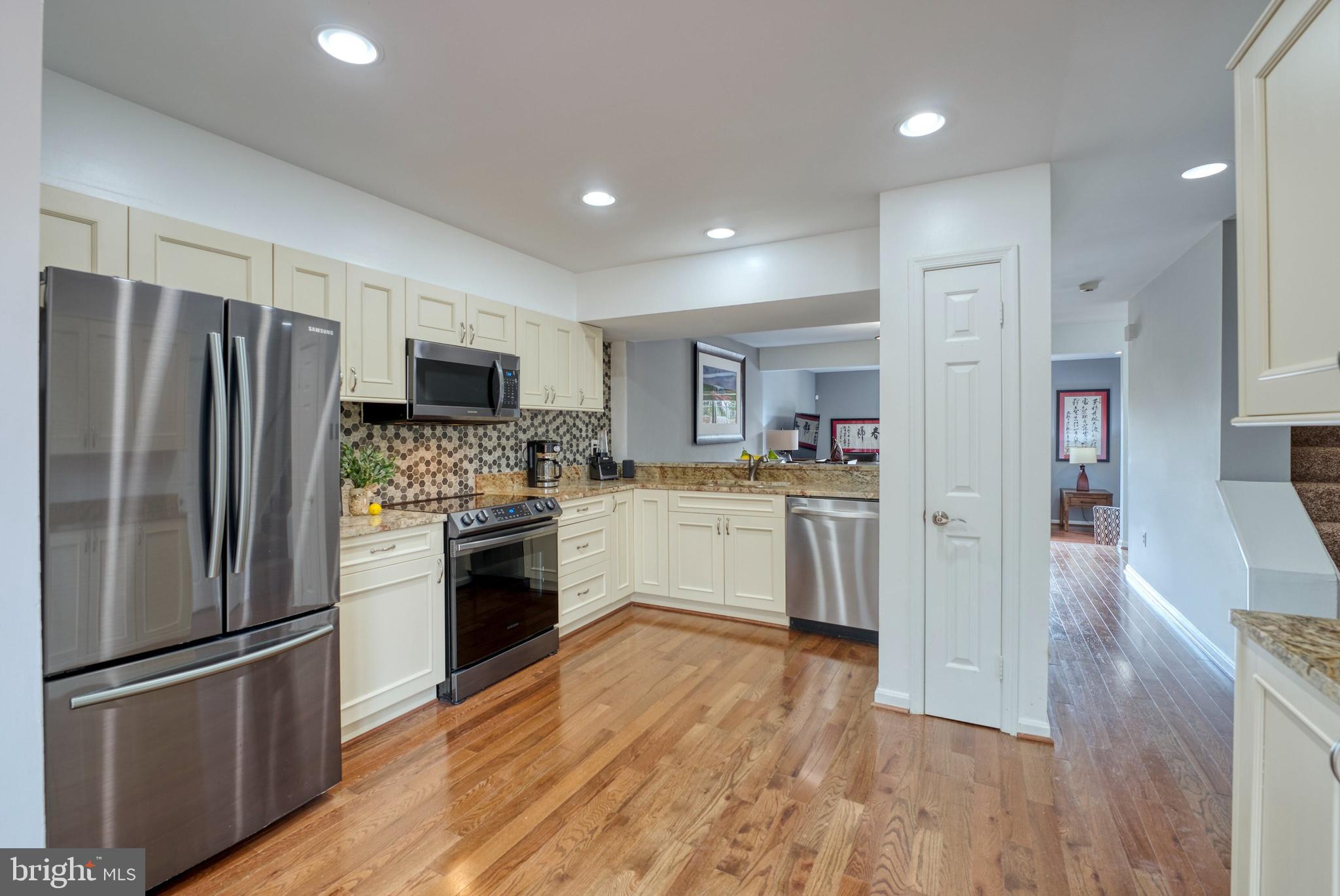 2041 Lyttonsville Road Silver Spring, MD 20910 - Photo 7 of 42 a kitchen with a refrigerator cabinets and wooden floor
