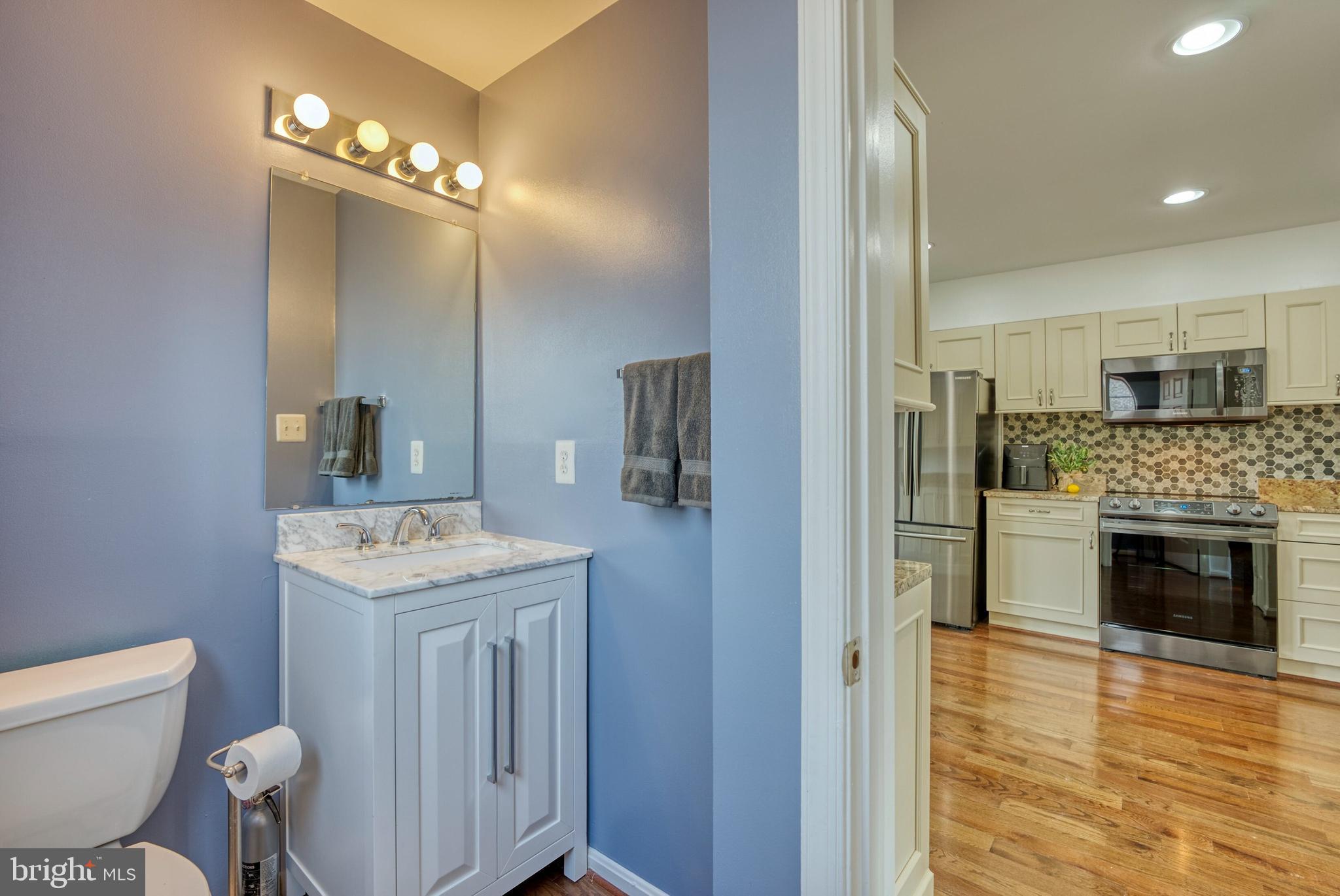 2041 Lyttonsville Road Silver Spring, MD 20910 - Photo 9 of 42 a bathroom with a sink a toilet a mirror and vanity