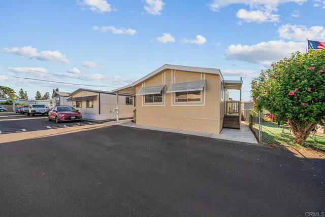 a car parked in front of a house with a street