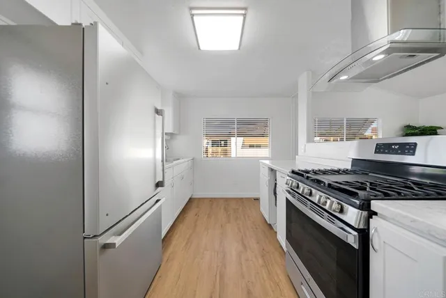 a kitchen with granite countertop a stove and a refrigerator