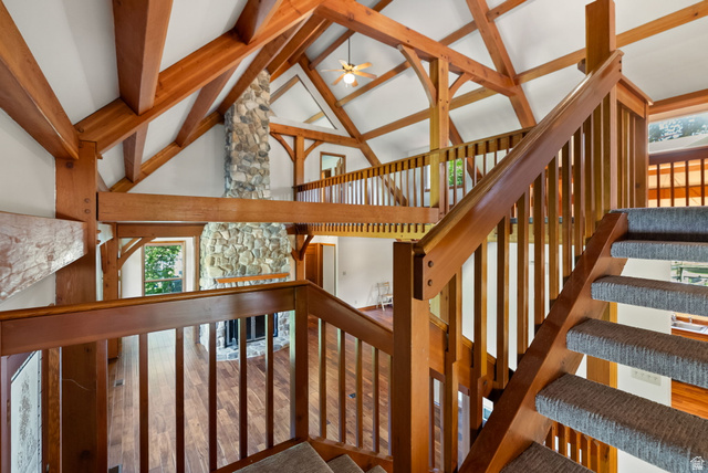 435 Canyon Road Millville, UT 84326 - Photo 25 of 113 Vaulted ceilings with exposed timber beams define this interior, featuring a stone fireplace
