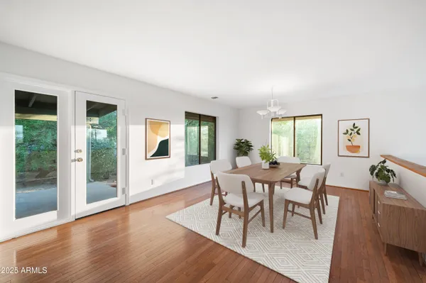a view of a dining room with furniture and wooden floor