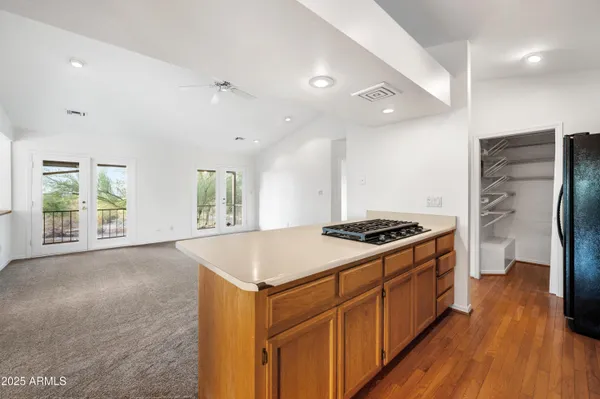 a kitchen with stainless steel appliances granite countertop a stove and a wooden floors