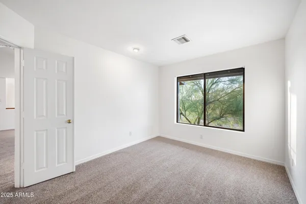 a kitchen that has a sink stainless steel appliances a counter space and a window