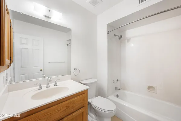 a bathroom with a sink toilet vanity and shower