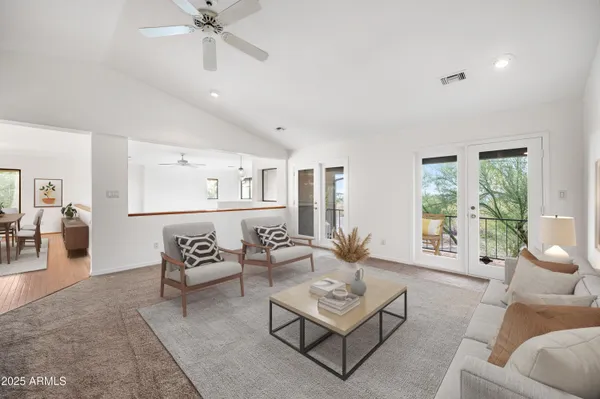 a living room with furniture kitchen view and a couch