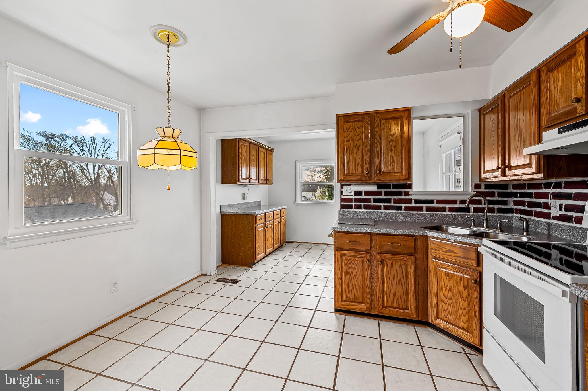 9382 North Laurel Road Laurel, MD 20723 - Photo 11 of 31 a kitchen with stainless steel appliances granite countertop a stove a sink and a refrigerator