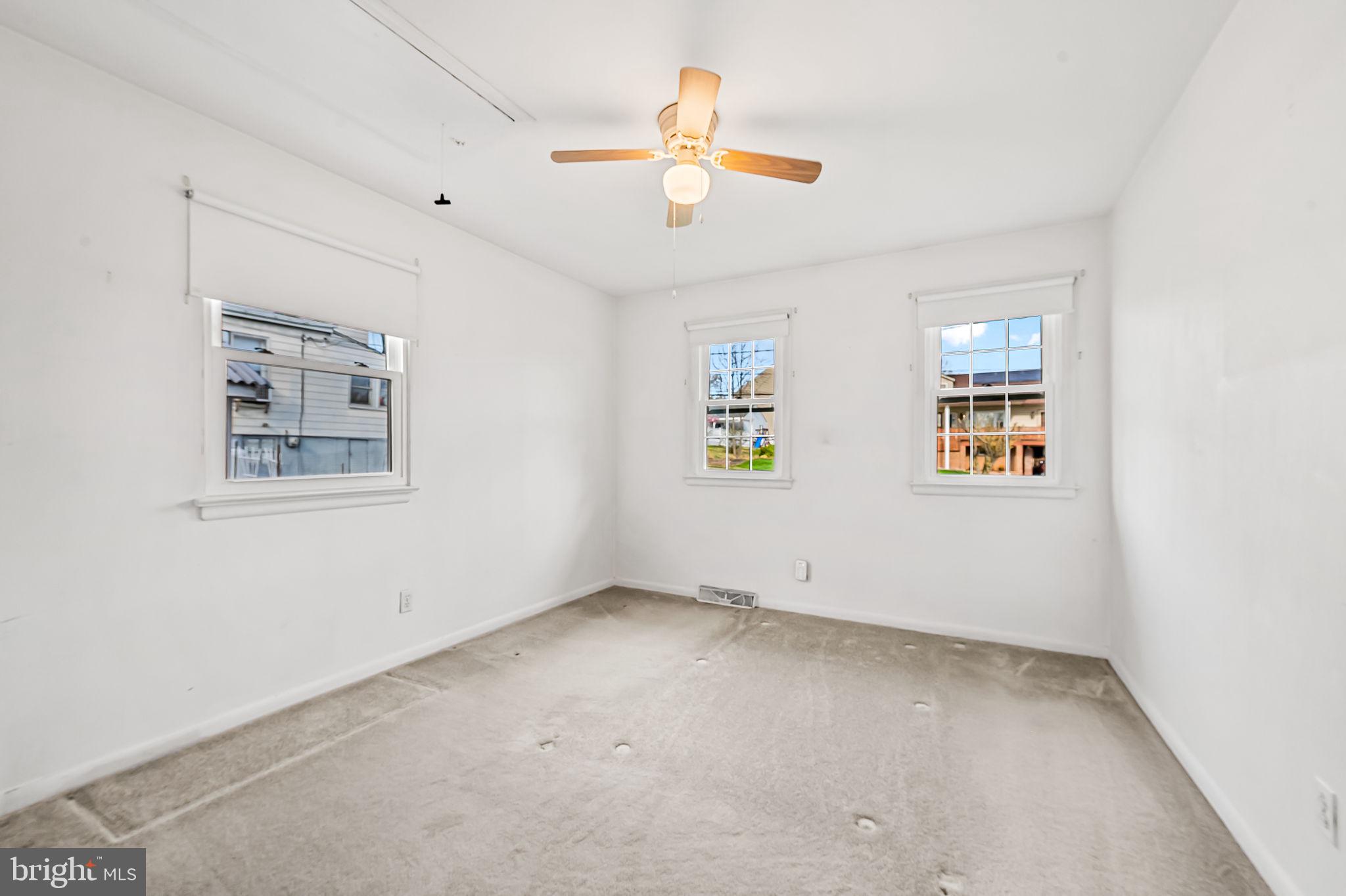 9382 North Laurel Road Laurel, MD 20723 - Photo 16 of 31 an empty room with windows and ceiling fan