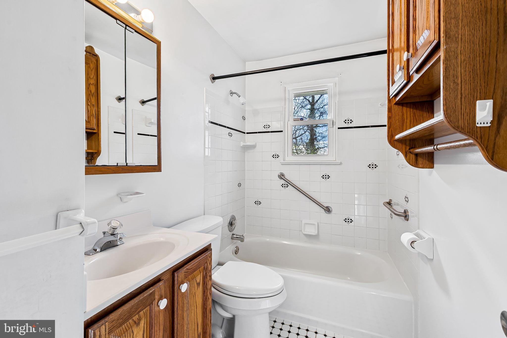 9382 North Laurel Road Laurel, MD 20723 - Photo 18 of 31 a bathroom with a sink a toilet and a mirror