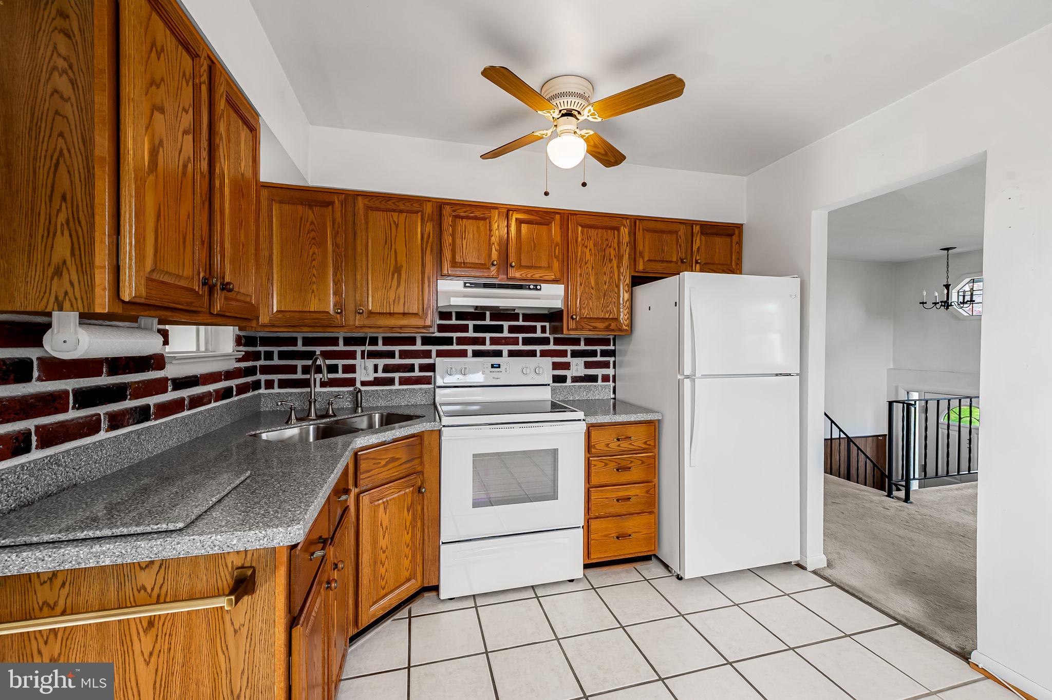 9382 North Laurel Road Laurel, MD 20723 - Photo 8 of 31 a kitchen with a sink a stove and a refrigerator