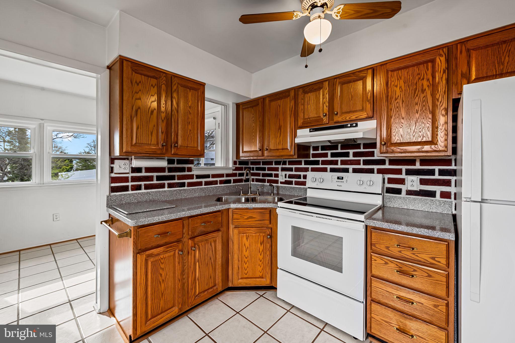 9382 North Laurel Road Laurel, MD 20723 - Photo 9 of 31 a kitchen with stainless steel appliances granite countertop a stove a sink and a refrigerator