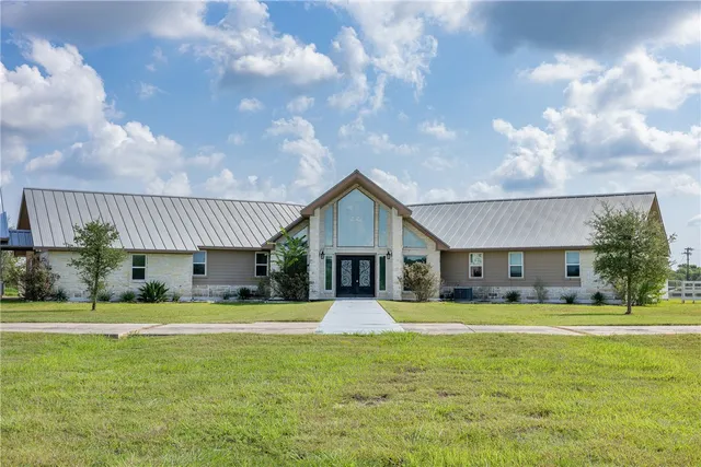 a house view with swimming pool and yard