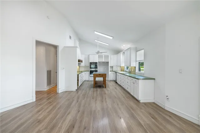 a kitchen with a refrigerator and a sink