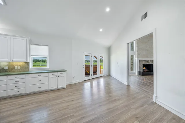 a large kitchen with hardwood and a sink