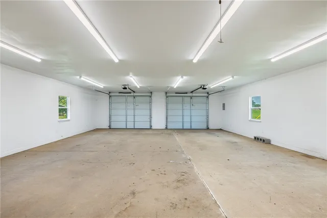 an empty room with a window and a garage