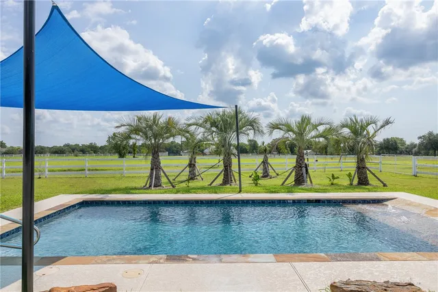 a view of swimming pool with a yard
