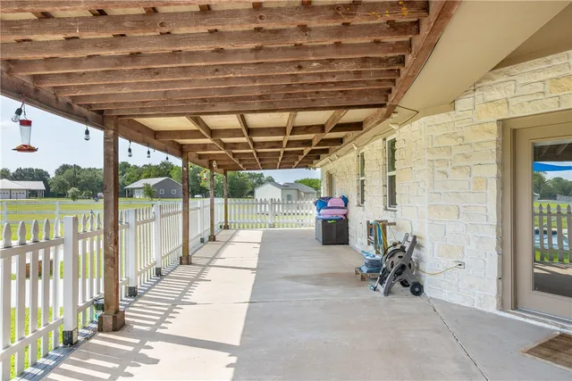a view of a patio with table and chairs
