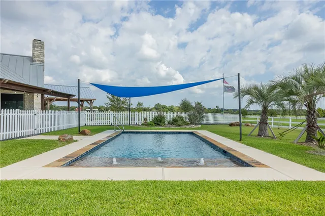 a view of swimming pool with a yard and sitting area