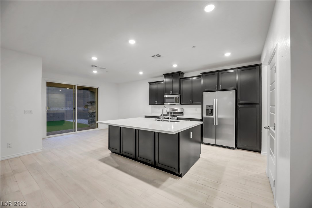 291 Robson Rdg Lane Henderson, NV 89015 - Photo 19 of 77 Kitchen features Quartz Countertop Island with Sto