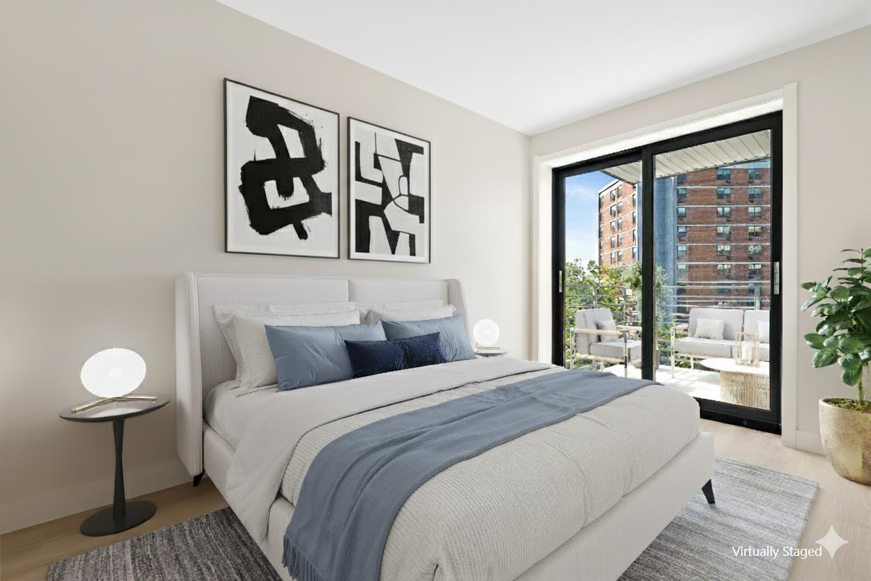 1546 Broadway, Unit 6B Brooklyn, NY 11233 - Photo 4 of 13 a bedroom with a bed and a painting on the wall