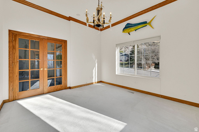 1085 Windsor Drive Provo, UT 84604 - Photo 24 of 83 Carpeted spare room with a chandelier, ornamental molding, and french doors