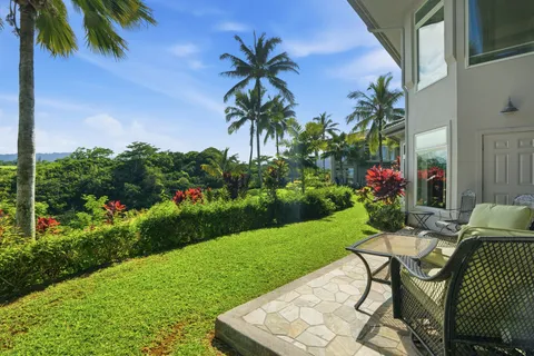 a view of a backyard with plants and a patio