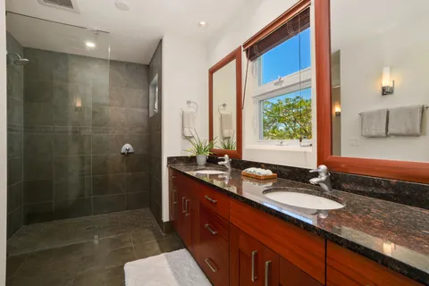a bathroom with a granite countertop sink mirror and double