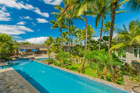 a view of a backyard with plants and a lake view