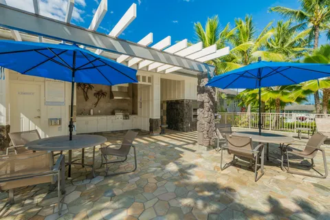 a patio with a table and chairs under an umbrella
