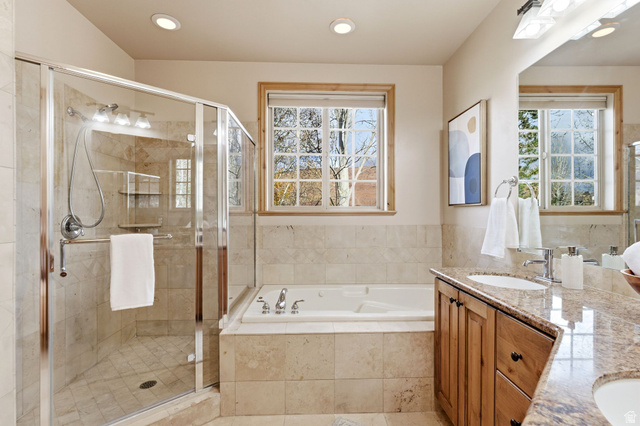 3026 Lower Saddleback Road Park City, UT 84098 - Photo 33 of 71 Bathroom with double vanity, a garden tub, a stall shower, healthy amount of natural light, and recessed lighting