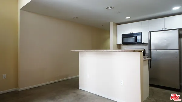 a view of a kitchen with a refrigerator a microwave and a refrigerator