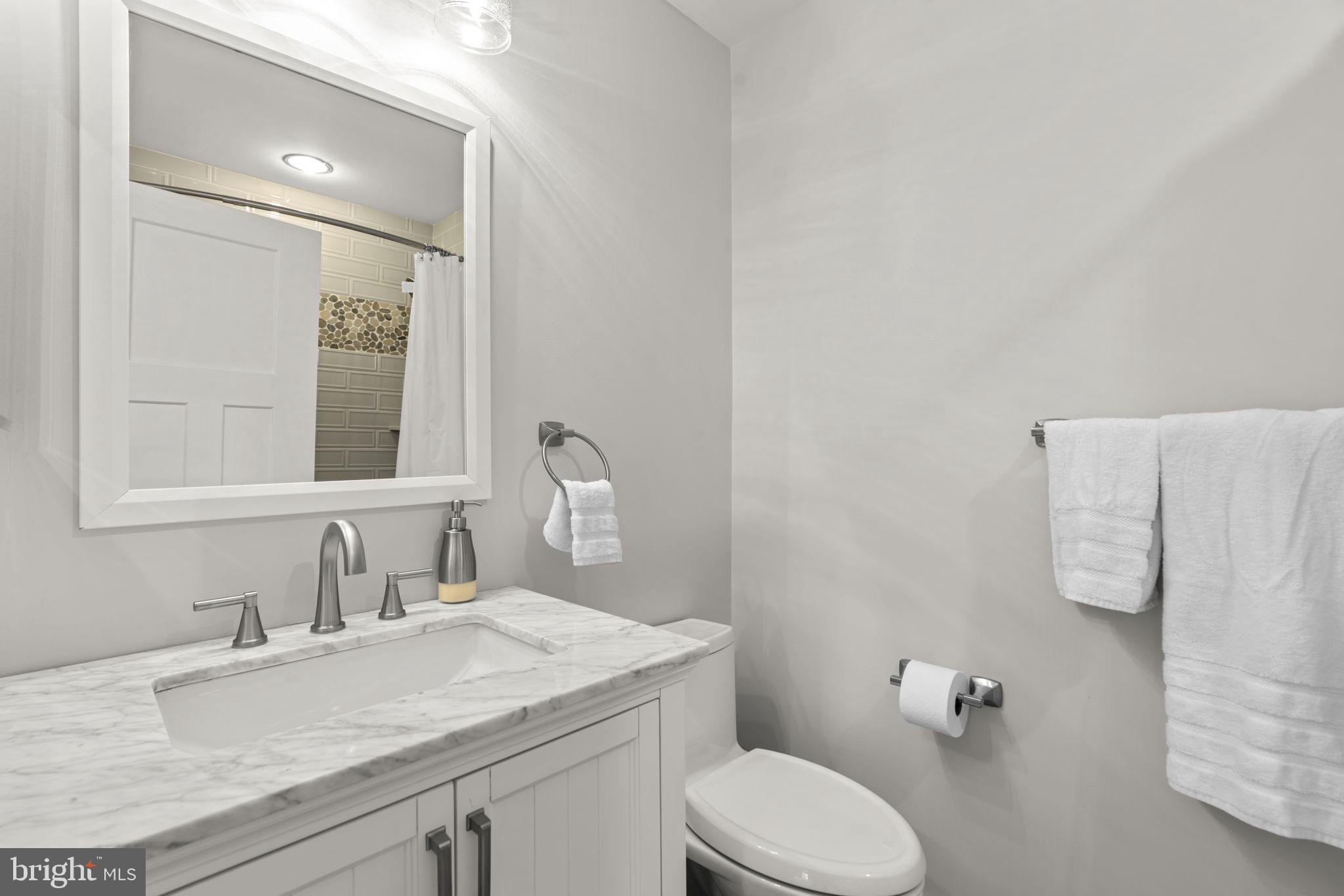 798 Creek View Road Severna Park, MD 21146 - Photo 34 of 72 a bathroom with a granite countertop sink mirror and toilet