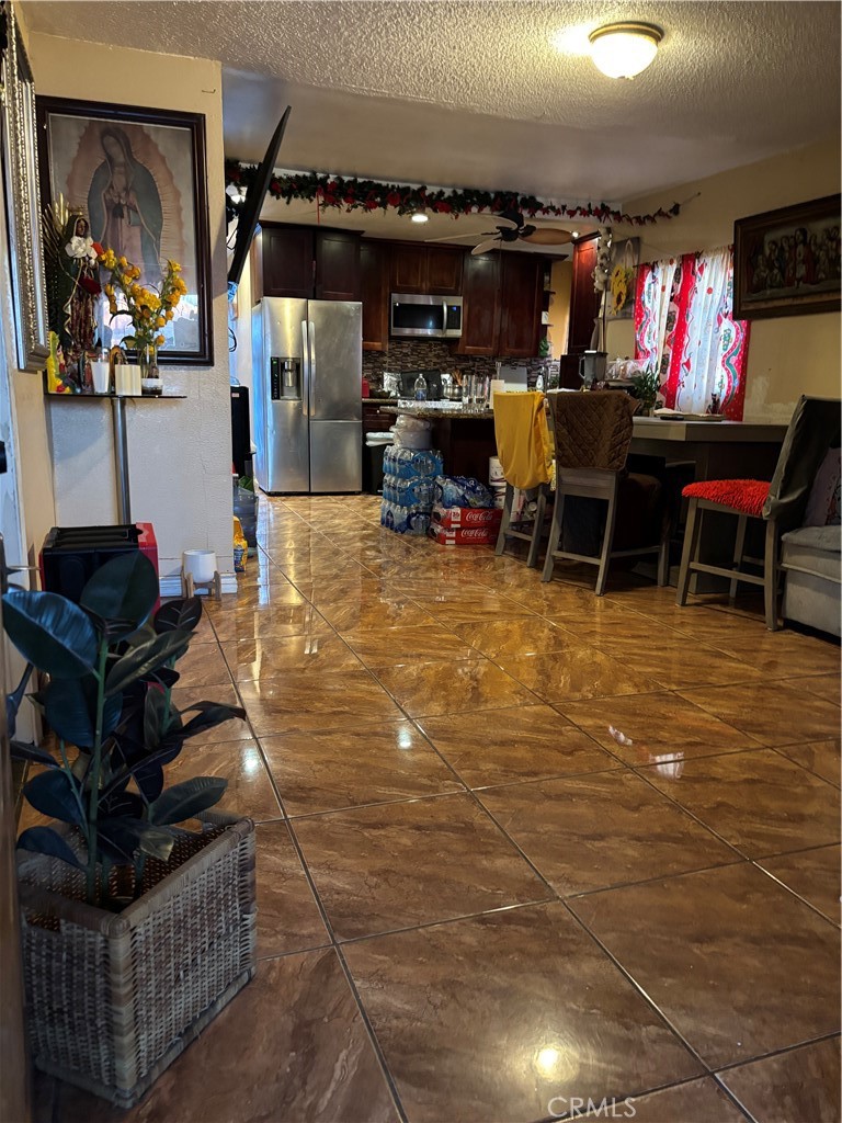 10821 Compton Los Angeles, CA 90059 - Photo 5 of 21 a room with lots of furniture and a flat screen tv