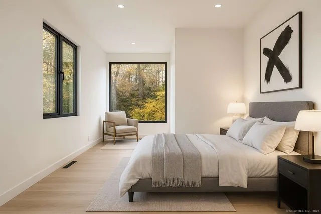 a bathroom with a sink a toilet and a large mirror
