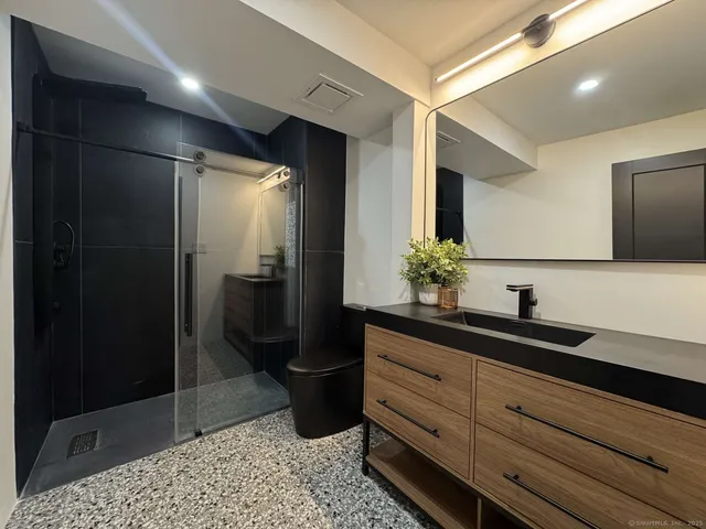 a living room with furniture a window and potted plant