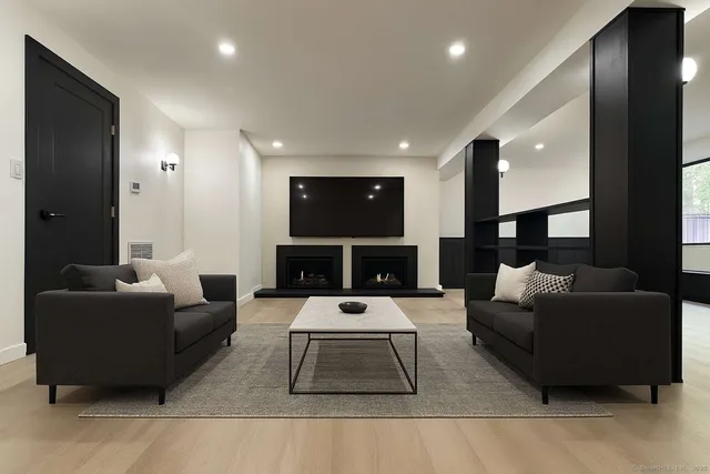 an empty room with large mirror and stairs