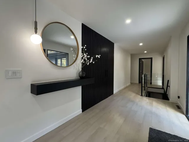 a lobby with a couch and a flat screen tv
