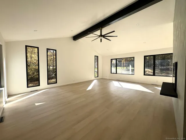 a room with a wooden floor and a window