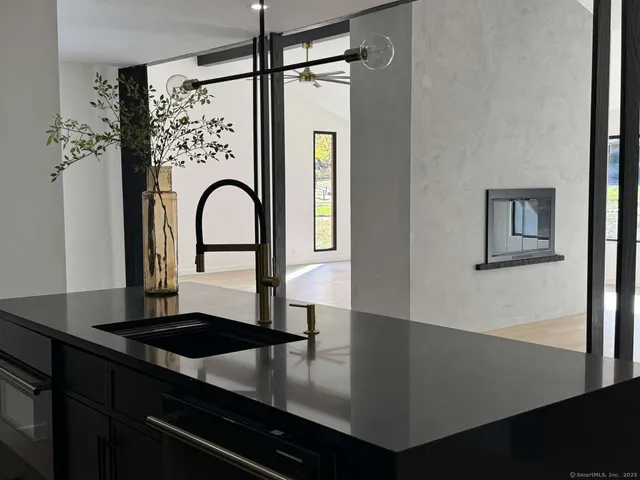 a kitchen with kitchen island a counter top space cabinets and stainless steel appliances