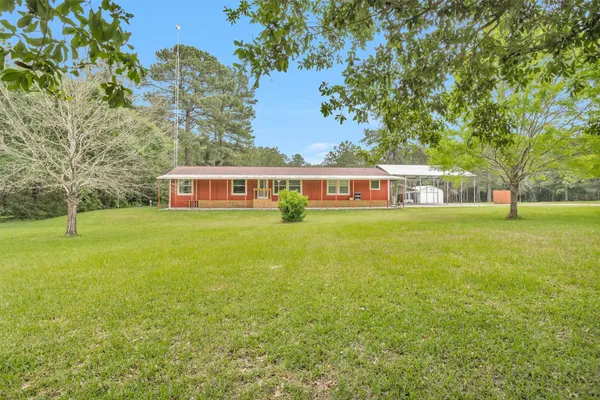 a view of house with a big yard