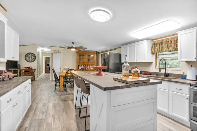 a kitchen with white cabinets stove and refrigerator