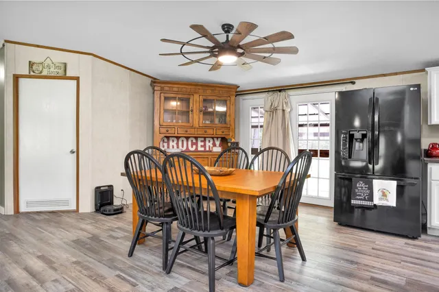 a view of a dining room with furniture and wooden floor
