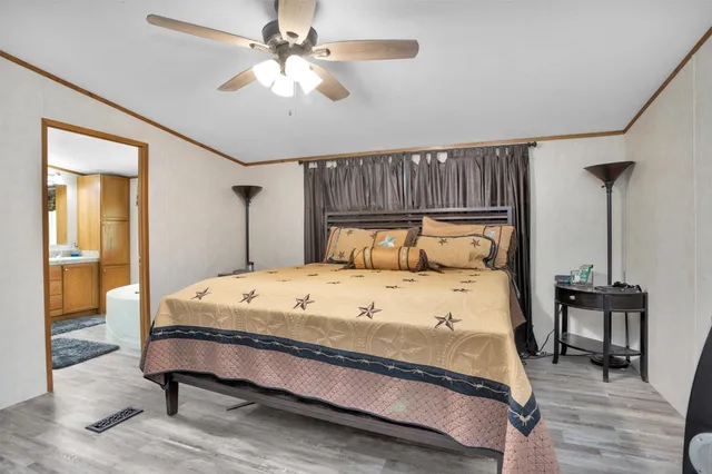 a bedroom with a bed a table and chair