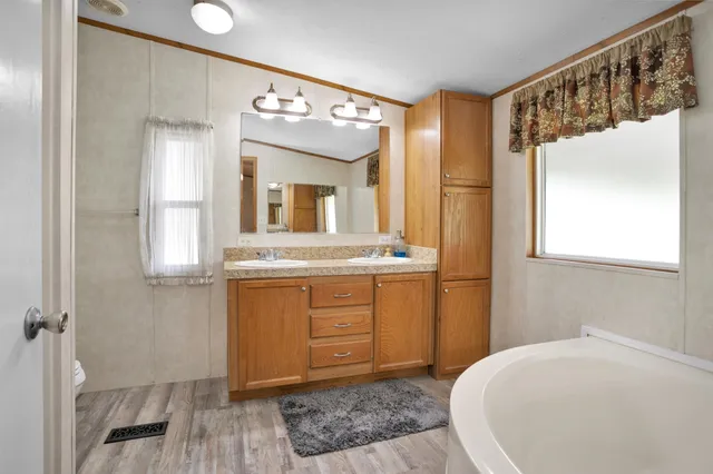 a bathroom with a sink a mirror and a toilet